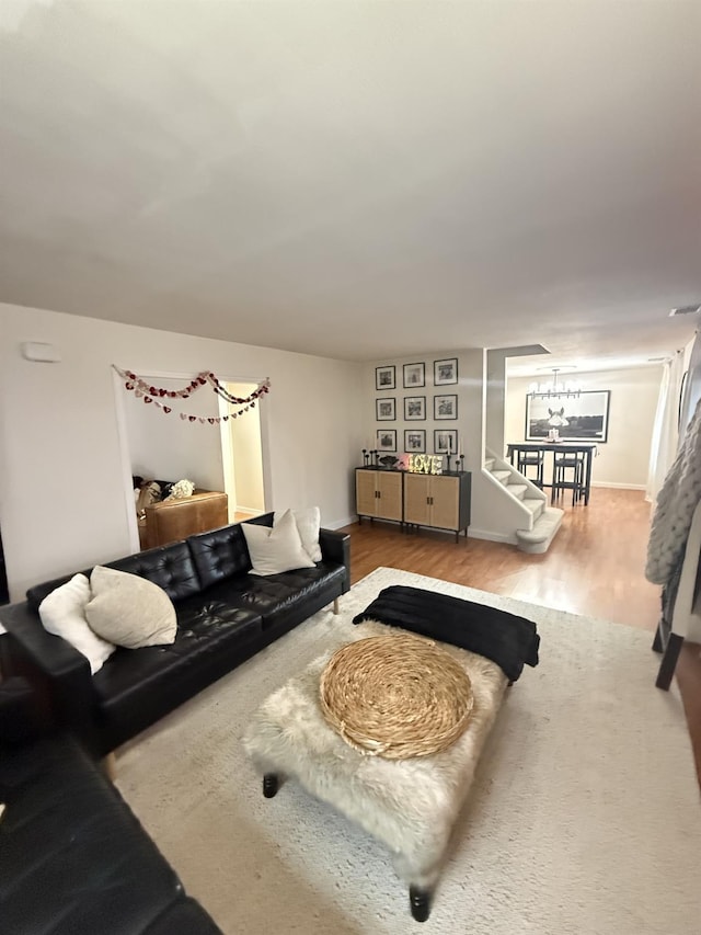 living room with stairs and wood finished floors