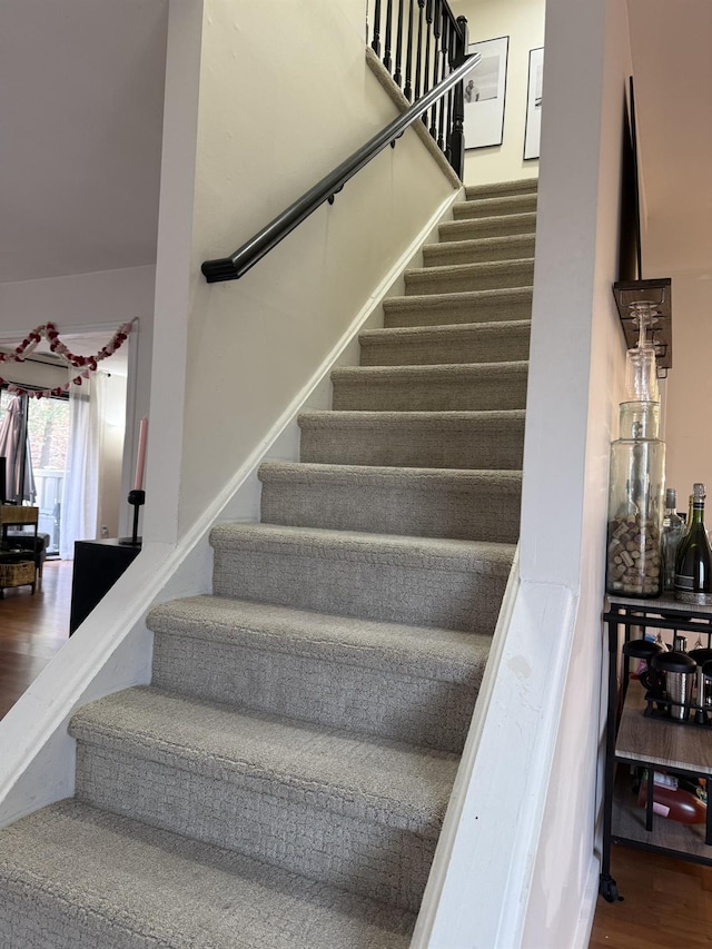 stairway with wood finished floors