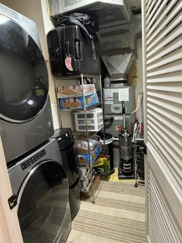 laundry room with stacked washer and dryer and laundry area