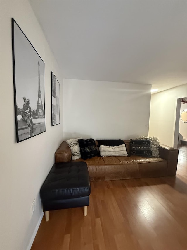 living area featuring wood finished floors and baseboards