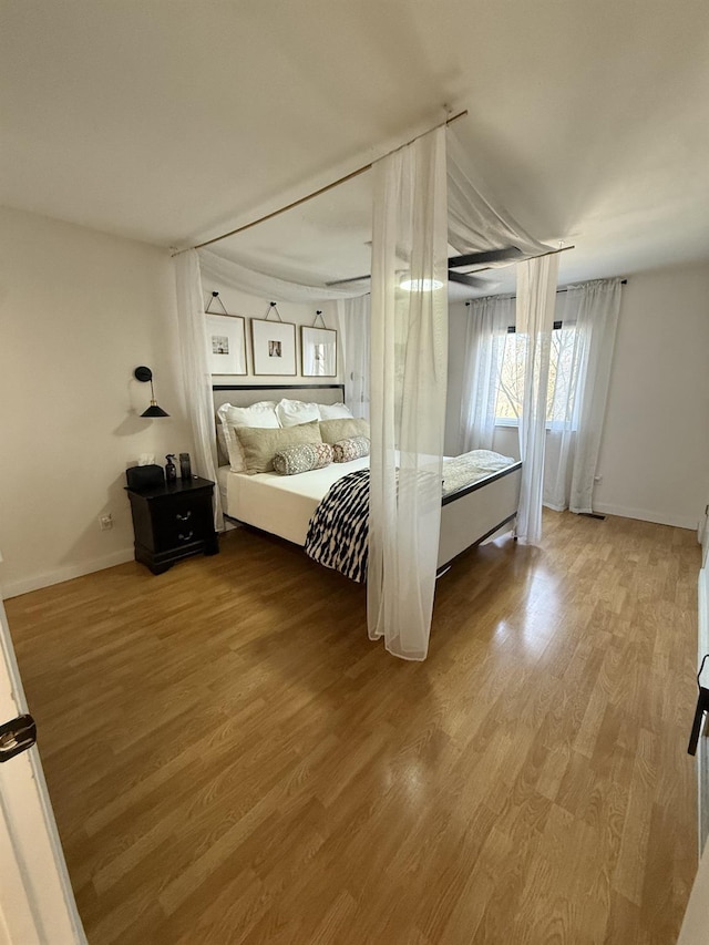 unfurnished bedroom featuring baseboards and wood finished floors