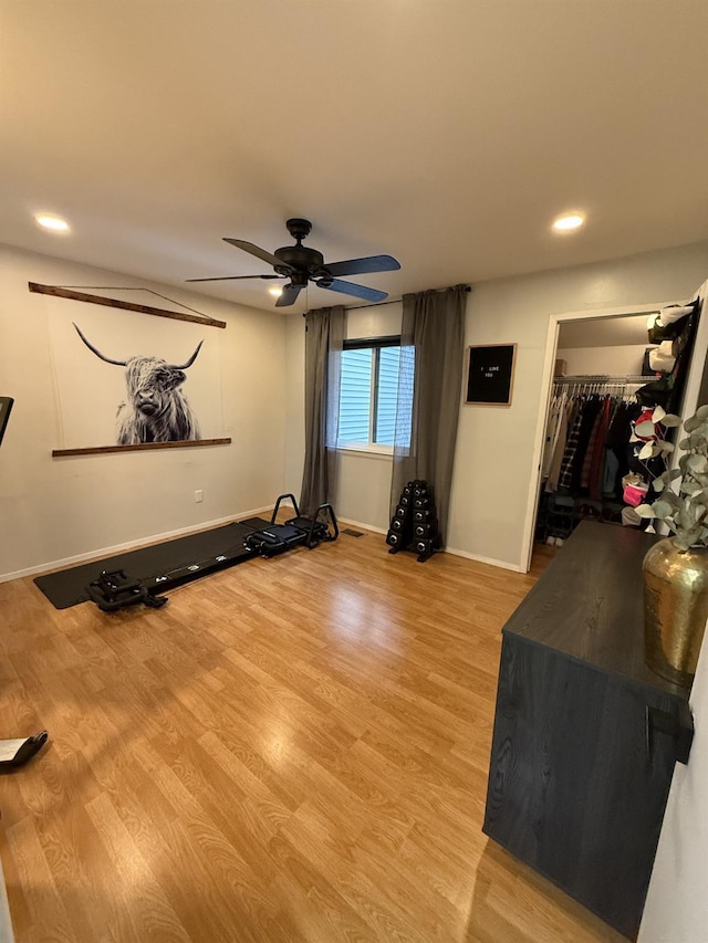 workout area featuring recessed lighting, baseboards, light wood-style floors, and ceiling fan