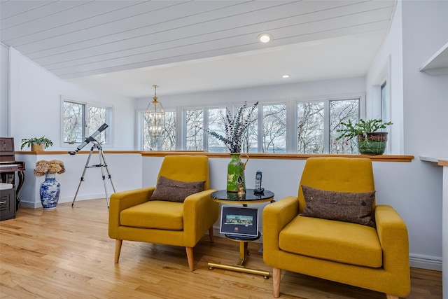 sitting room with a chandelier, recessed lighting, baseboards, and wood finished floors