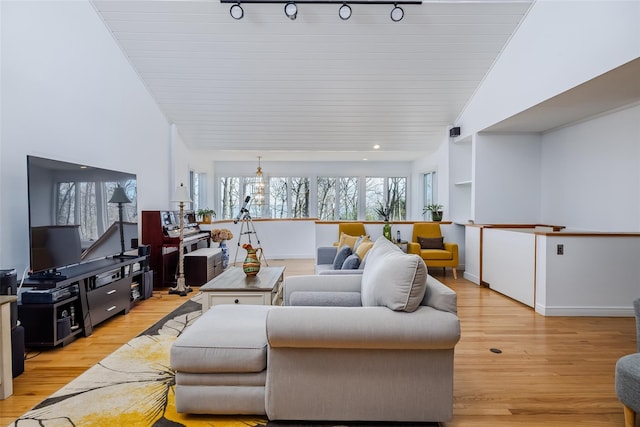 living area with baseboards and light wood finished floors