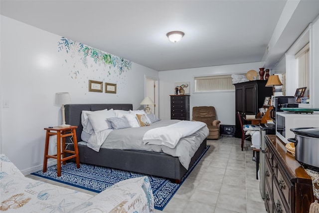 bedroom featuring light tile patterned flooring and baseboards