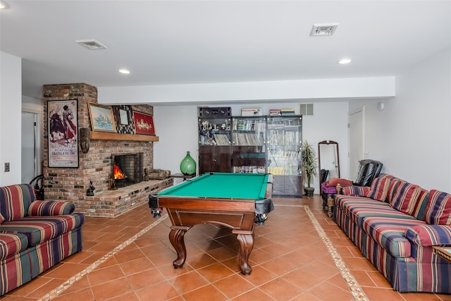 recreation room with tile patterned floors, visible vents, and a fireplace