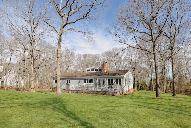 view of front of house with a chimney and a front lawn