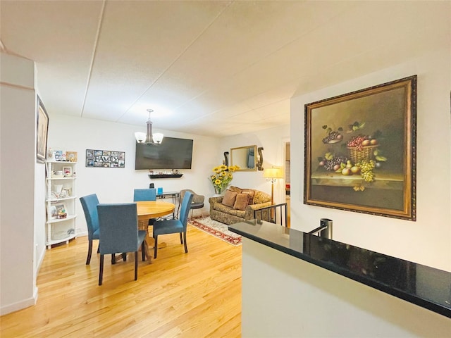 dining space with a notable chandelier and light wood-style flooring