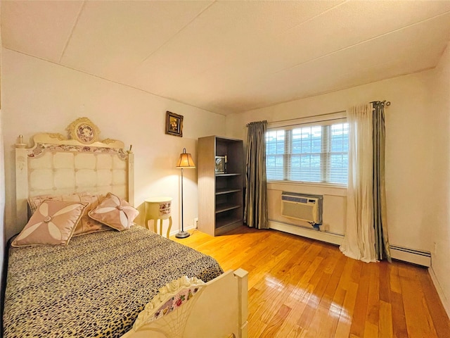 unfurnished bedroom with hardwood / wood-style floors, a baseboard radiator, and a wall mounted AC