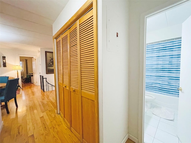 corridor featuring light wood finished floors