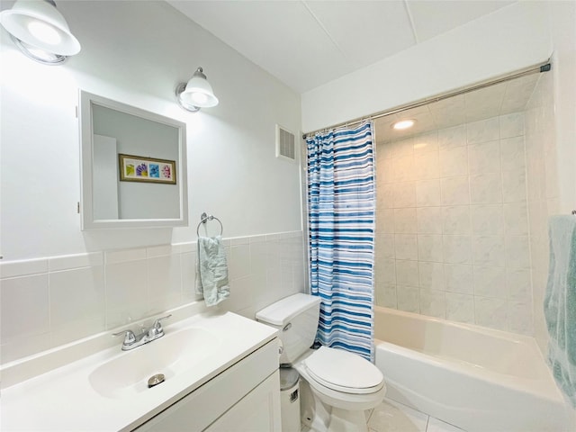 full bath with vanity, visible vents, shower / bath combination with curtain, tile walls, and toilet