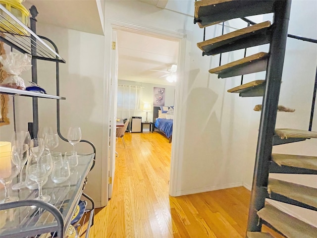 hallway with light wood-style flooring and baseboards