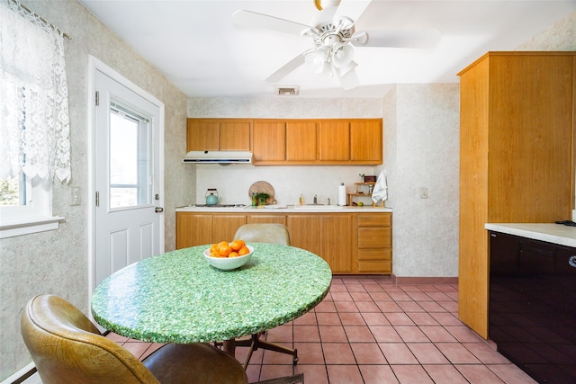 kitchen featuring gas cooktop, light tile patterned floors, a ceiling fan, extractor fan, and light countertops