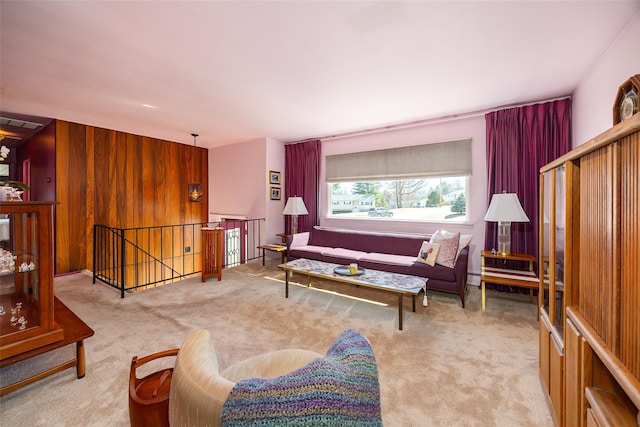 living room with carpet flooring, wood walls, and baseboard heating