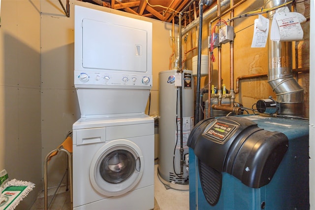 clothes washing area with gas water heater, stacked washer / drying machine, and laundry area