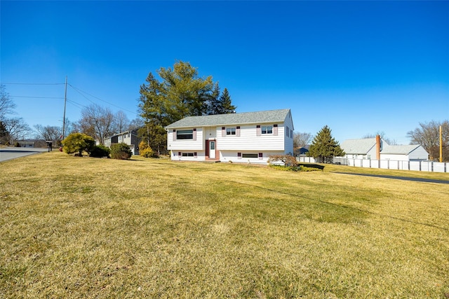 back of property with a yard, entry steps, and fence