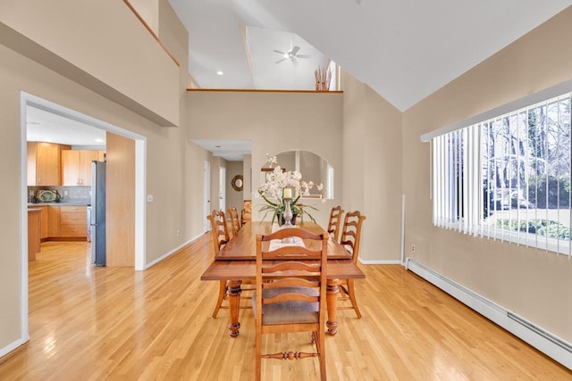 1380 Jackson Lndg, Mattituck, NY 11952 - dining area with light wood-style flooring, high vaulted ceiling, baseboards, and a baseboard radiator