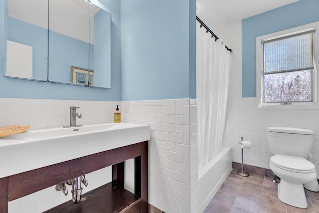 1380 Jackson Lndg, Mattituck, NY 11952 - bathroom featuring tile walls, toilet, a wainscoted wall, and tile patterned floors