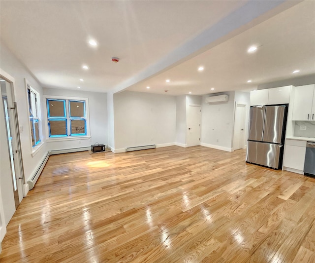 unfurnished living room with a wall mounted air conditioner, a baseboard heating unit, light wood-style floors, and recessed lighting