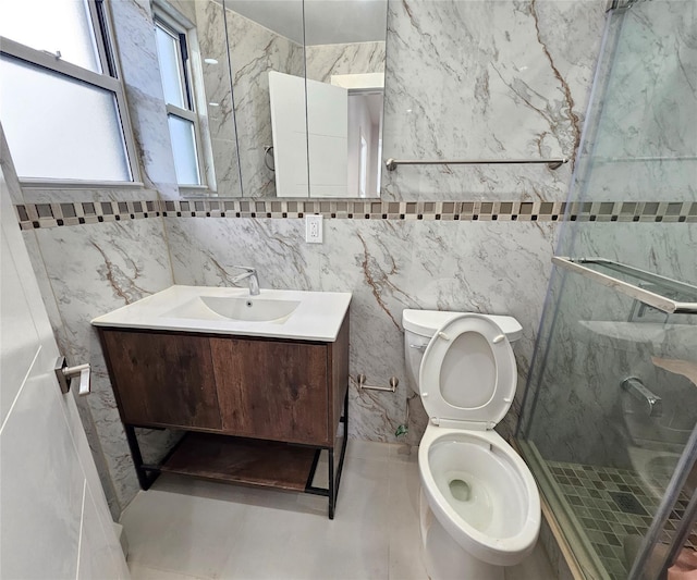 bathroom featuring vanity, a shower stall, and toilet