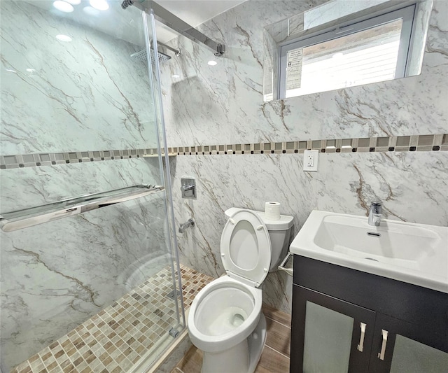 full bathroom with vanity, toilet, and a marble finish shower