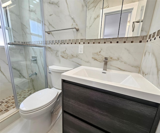 bathroom featuring toilet, tasteful backsplash, a marble finish shower, tile walls, and vanity