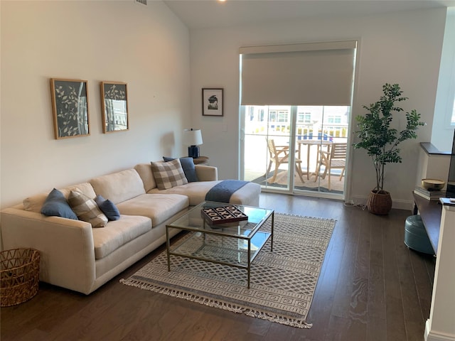 living room featuring visible vents, baseboards, and wood-type flooring