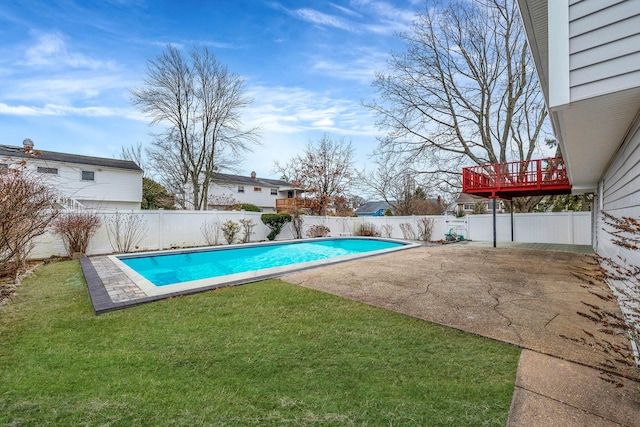 view of swimming pool featuring a patio, a fenced in pool, a fenced backyard, and a lawn