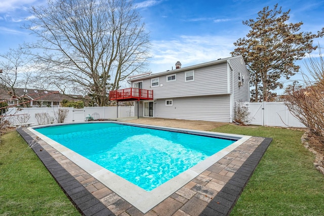 view of pool featuring a fenced in pool, a wooden deck, a lawn, a fenced backyard, and a gate