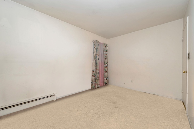 empty room featuring a baseboard radiator and carpet