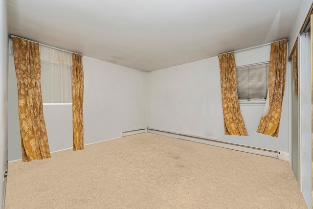 carpeted spare room with baseboard heating