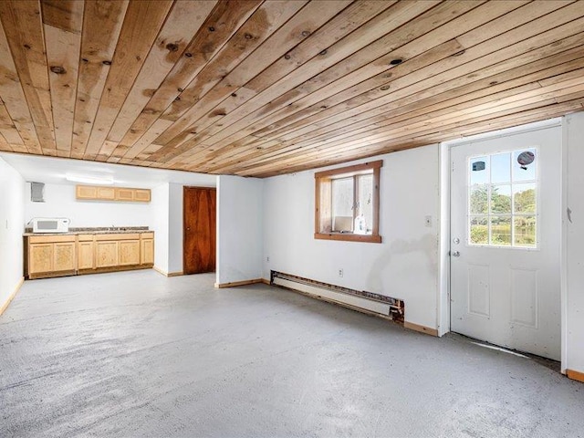 unfurnished living room with baseboard heating, concrete flooring, wooden ceiling, and baseboards