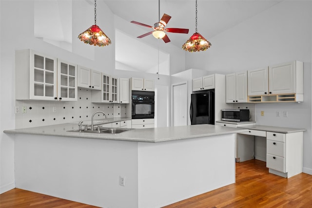 kitchen featuring black appliances, a sink, high vaulted ceiling, a peninsula, and ceiling fan