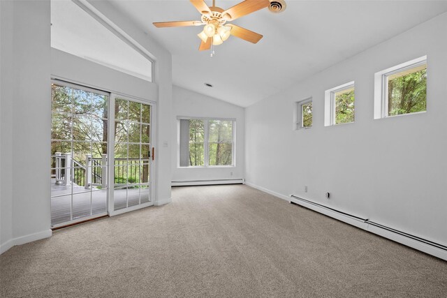 spare room featuring a baseboard heating unit, lofted ceiling, plenty of natural light, and carpet floors