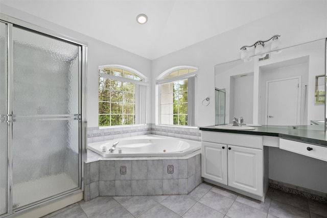 bathroom with a whirlpool tub, a shower stall, tile patterned floors, and vanity