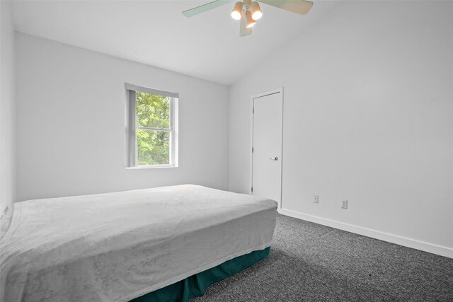 bedroom featuring carpet, vaulted ceiling, baseboards, and ceiling fan