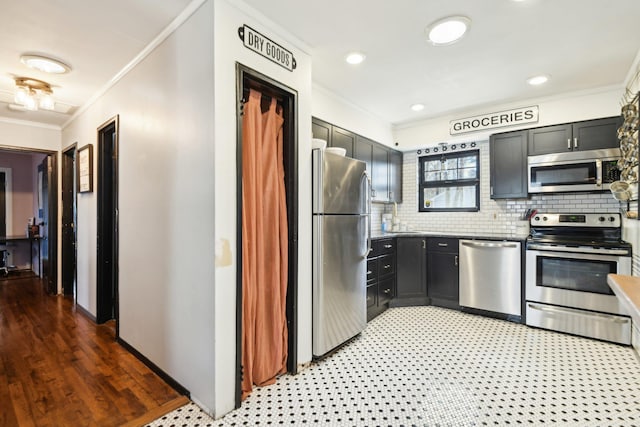 kitchen with backsplash, crown molding, light floors, recessed lighting, and appliances with stainless steel finishes