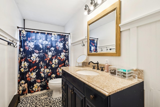 bathroom with a shower with shower curtain, toilet, vanity, and tile patterned flooring