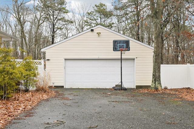 detached garage featuring fence