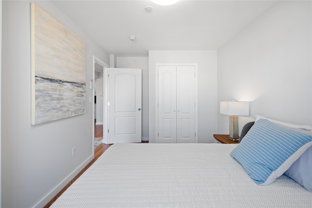 bedroom with a closet and baseboards