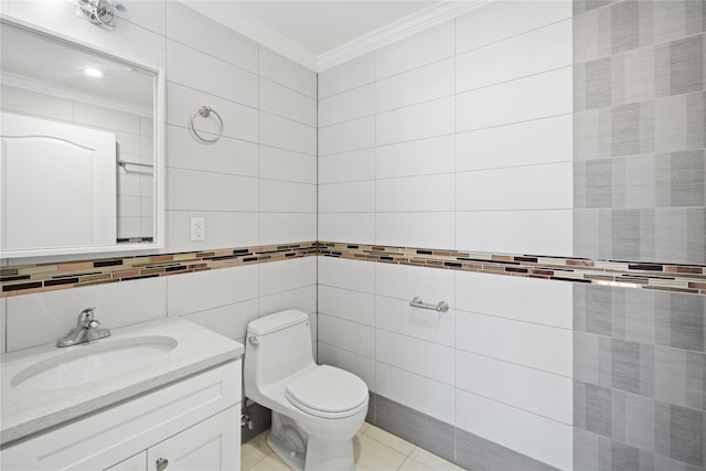 bathroom featuring tile patterned flooring, crown molding, toilet, vanity, and tile walls