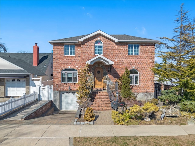 view of front of home with a garage, fence, brick siding, and driveway