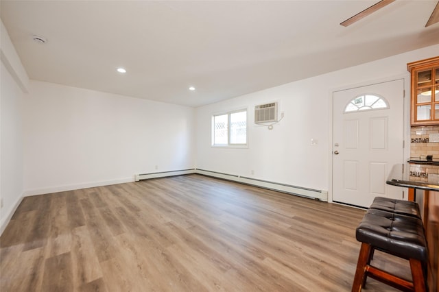 foyer entrance featuring a baseboard radiator, light wood-style flooring, recessed lighting, ceiling fan, and a wall mounted air conditioner