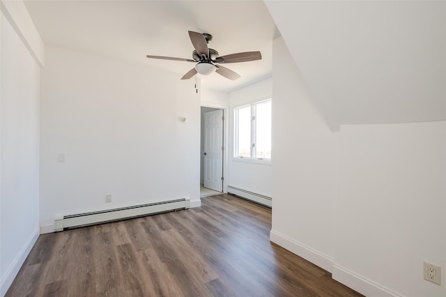 spare room featuring a ceiling fan, a baseboard heating unit, wood finished floors, a baseboard radiator, and baseboards