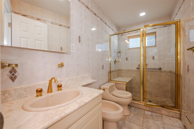 full bathroom featuring vanity, a bidet, a shower stall, tile walls, and toilet