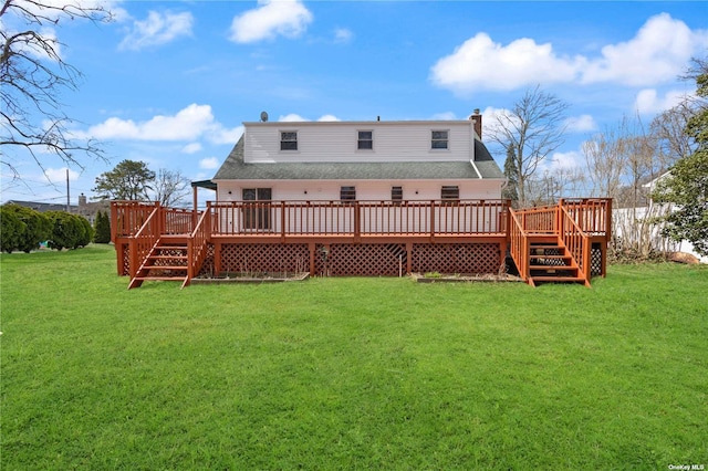 back of property featuring a deck, a chimney, a yard, and roof with shingles