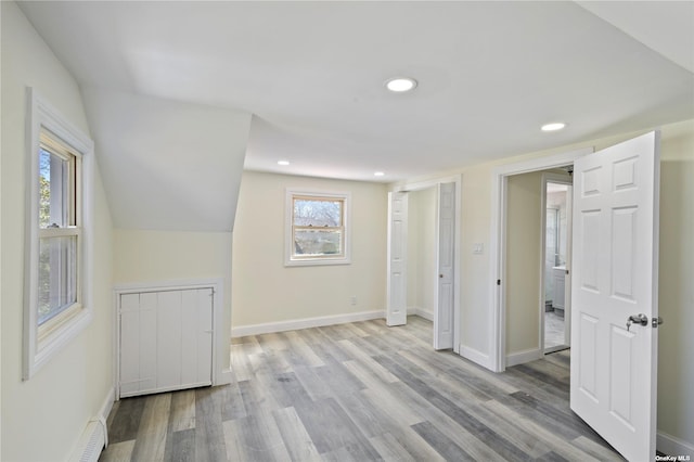 unfurnished bedroom featuring lofted ceiling, recessed lighting, wood finished floors, and baseboards