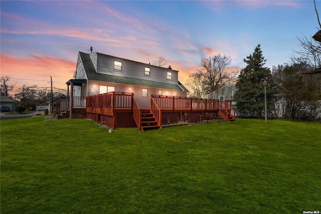 rear view of house with a lawn, a wooden deck, and a shingled roof