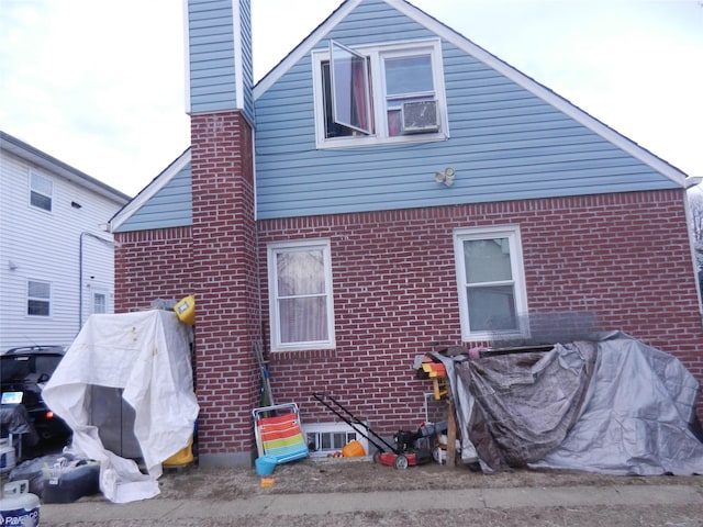 rear view of house featuring brick siding