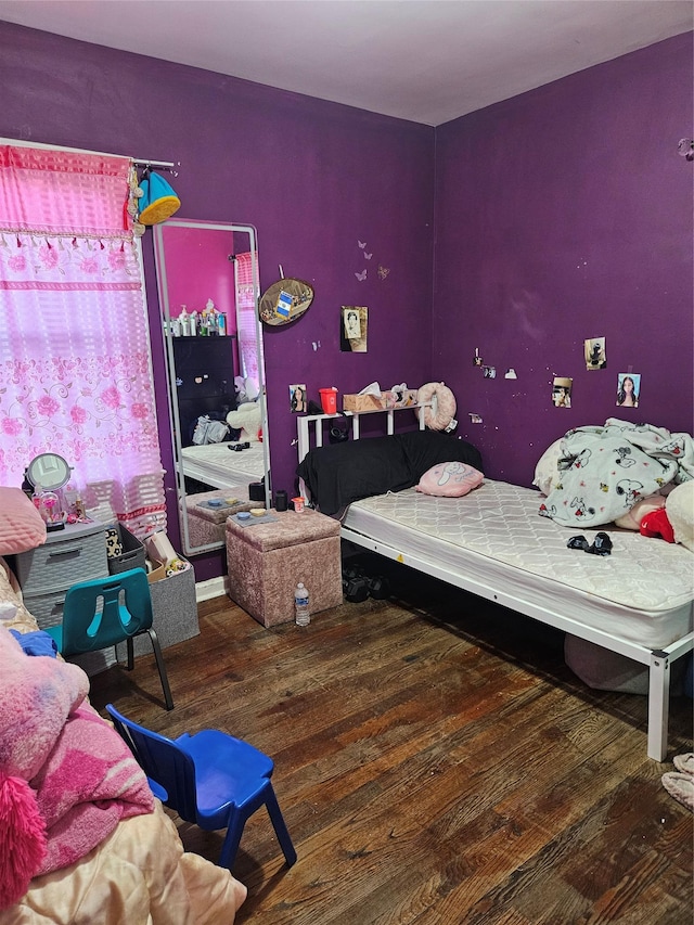 bedroom with wood finished floors